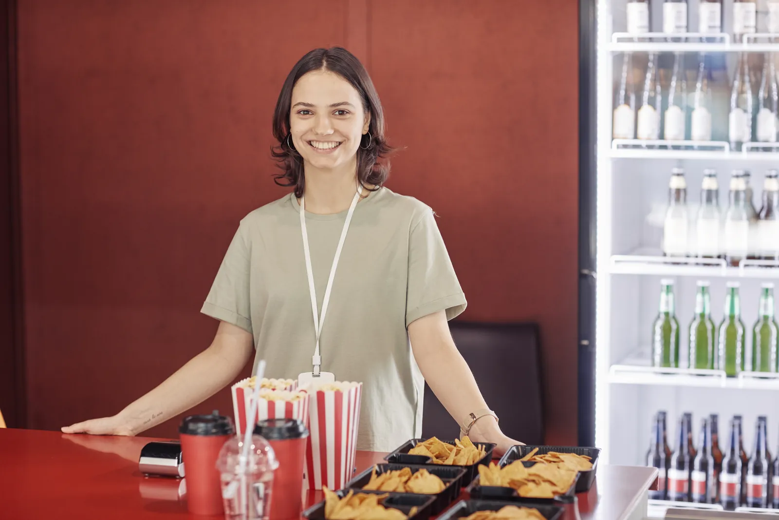 Funcionária sorrindo no balcão de atendimento de um comércio